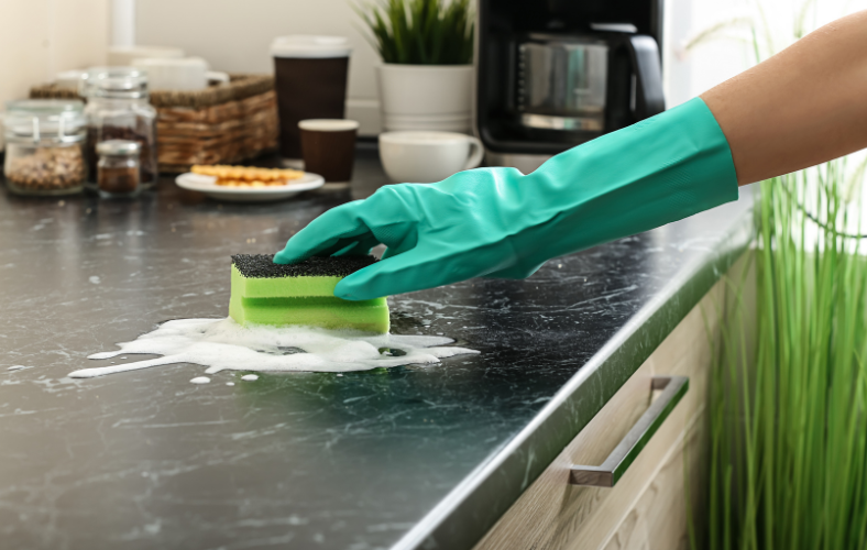 Woman cleaning kitchen countertops